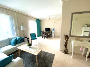 a living room with a couch and a table at Квартира рядом с морем in Kemer