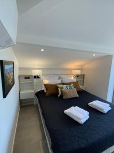 a bedroom with a large bed with blue sheets and pillows at Le Rooftop Tropézien in Saint-Tropez +55 photos