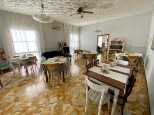 a dining room with tables and chairs and a ceiling at Villa Mirna in Rimini