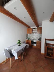 a dining room with a table and a kitchen at Torre del Moro in Domodossola