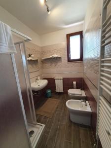 a bathroom with two sinks and two toilets at Sonnellino in Maremma in Massa Marittima
