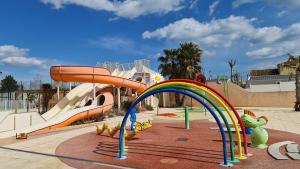 a playground with a slide in a park at Les sable du midi 3 in Valras-Plage