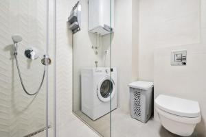 a bathroom with a washing machine in a shower at Soho Magic Lux in Bar +28 photos