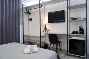 TV a/nebo společenská místnost v ubytování FamiliaINN Rooms & Apartments