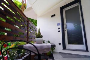 a patio with a table and a glass door at FamiliaINN Rooms & Apartments in Pompei