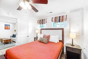 a bedroom with a bed and a ceiling fan at Beach Bum Bungalow in Folly Beach