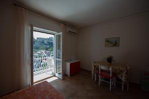 a room with a table and a window with a view at Appartamenti Attilio in Tropea