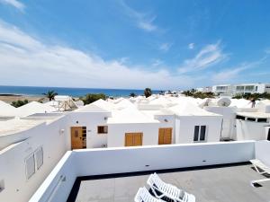 a view of the beach from the balcony of a house at Luxury Coral Beach first line of the sea in Playa Honda