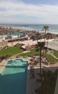 a view of a resort with a swimming pool and the beach at Breathtaking Oceana Del Mar in Rosarito