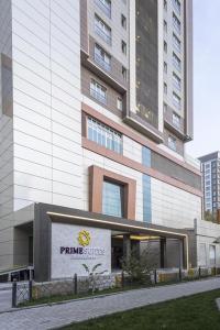 a large building with a sign in front of it at Sheraton Apartments in Bishkek