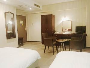 Postel nebo postele na pokoji v ubytování Smile Hotel Kitaasaka