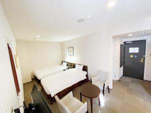 Postel nebo postele na pokoji v ubytování Smile Hotel Kitaasaka