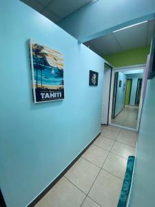 a room with a blue wall and a blue floor at Mahana Lodge Hostel & Backpacker in Papeete
