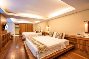 Postel nebo postele na pokoji v ubytování Pandawa All Suites Hotel