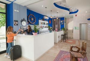 two women standing at a counter in a store at Hotel Holiday Sunshine Summer in Misano Adriatico