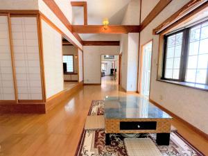 a living room with a table on a rug at Mariudo / Two-Bedroom & a Japanese-style-room House in Ishigaki Island