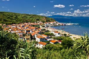 a small town on the shore of a body of water at Apartments VESNA (63) in Veli Lošinj