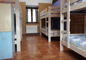 a room with bunk beds in a house at Albergue La Vargona in Camaleño