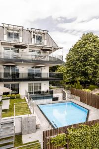 an apartment with a swimming pool and a building at AMELIA rooms in Tirolo