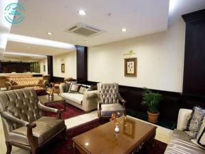 a living room with couches chairs and a table at Maywood Hotel in Istanbul