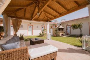 an outdoor patio with a couch and a fireplace at Anna Studios in Agios Georgios