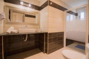 a bathroom with a sink and a shower at Anna Studios in Agios Georgios