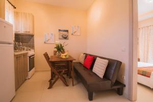 a small kitchen with a couch and a table in a room at Anna Studios in Agios Georgios +32 photos