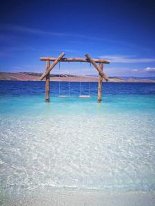 a swing in the middle of the ocean at Apartment Dom in Jadranovo