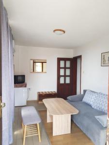 a living room with a couch and a table at Slantse in Sozopol
