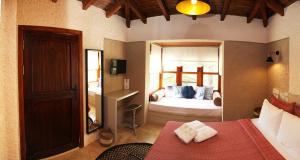 a bedroom with a bed and a large mirror at ZEVKLİLER ALAÇATI hotel in Alacati