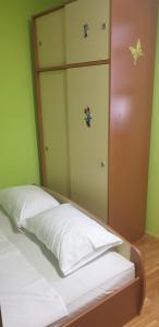 a bed in a room with butterflies on the wall at Nika apartment in Piran