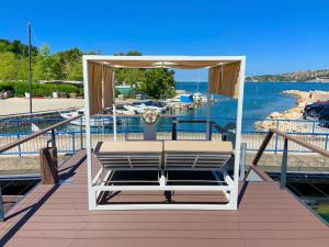 a bench on a deck with a view of the water at SH Porto 2 Floating House, Marina Portorož in Portorož