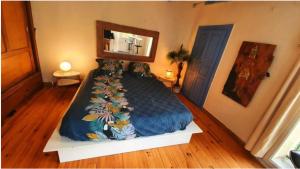 a bedroom with a large bed with a blue blanket at A Casa Catalina B&B in Ucciani