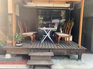 a table and chairs sitting on a wooden deck at 田舎の宿 吉田屋 in Ōgo