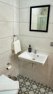 a bathroom with a sink and a toilet at KAJU ROOMS Bozburun in Bozburun