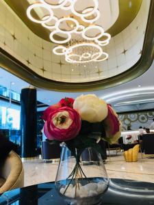 a vase filled with flowers sitting on a table at Downtown Dubai, Damac Maison Upper Crest in Dubai