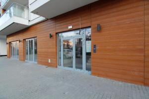 a building with glass doors on the side of it at Blue River - Pulaskiego B - private Apartment in Wrocław