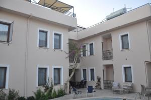 a large white building with a courtyard at Dalyando Apart in Dalyan