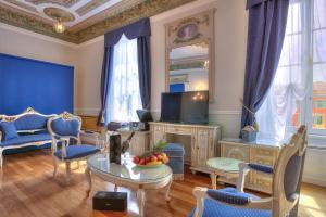 a living room with blue chairs and a tv at ABA LUXURY B E B Nice in Nice