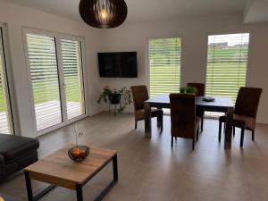 a living room with a dining room table and chairs at FEWO Sunshine in Villingen-Schwenningen