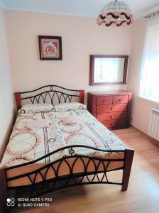 A bed or beds in a room at Apartament Bieszczady