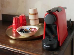 a toaster sitting on a table next to a bowl at MaDamenFrance in Monclar-dʼAgenais
