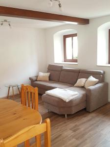 a living room with a couch and a table at Ferienwohnung-Max-22 in Müglitztal