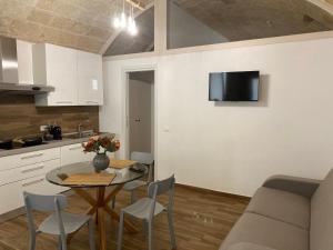 a kitchen and dining room with a table and chairs at La Maison dello zio in Monopoli