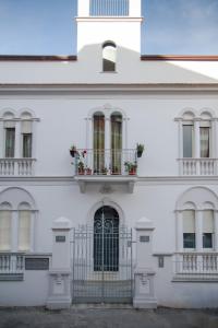 a white building with two balconies and a door at Le Bifore in Gaeta