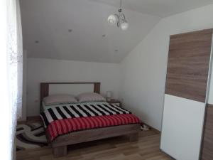 a bedroom with a bed with two pillows on it at Apartman Karmen Gospić in Gospić