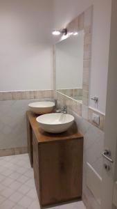 a bathroom with two sinks and a mirror at La casa di Pier in Olbia
