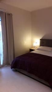 a bedroom with a bed and a large window at La casa di Pier in Olbia