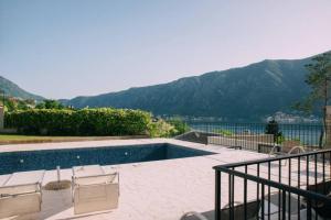 a swimming pool with a view of a mountain at PETRA STUDIO in Kotor