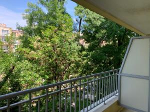 a balcony with a view of trees and buildings at PS Summer Dreams Apartments in Sunny Beach
